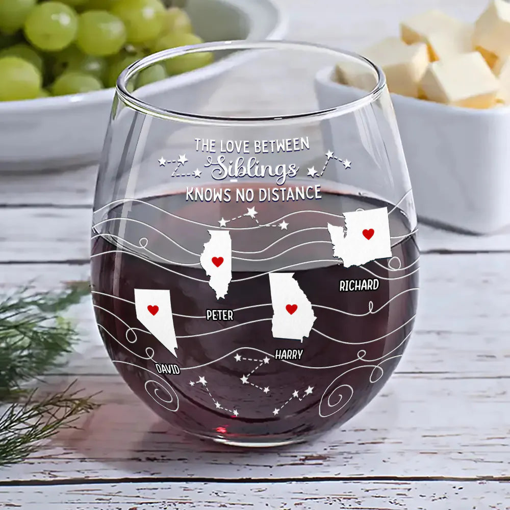 Personalized stemless wine glass with state map design, filled with red wine, ideal for family gatherings.