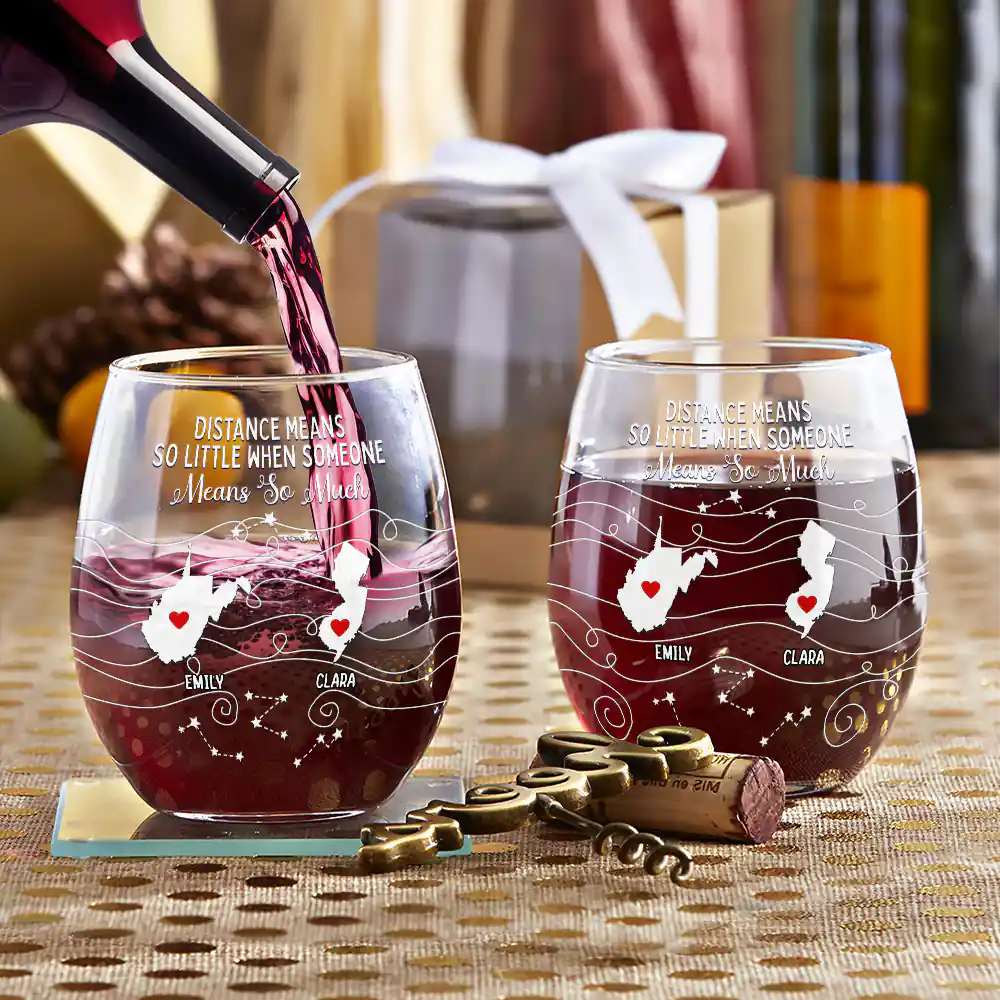 Personalized stemless wine glasses with state maps, being filled with red wine. Gift for family, friends.