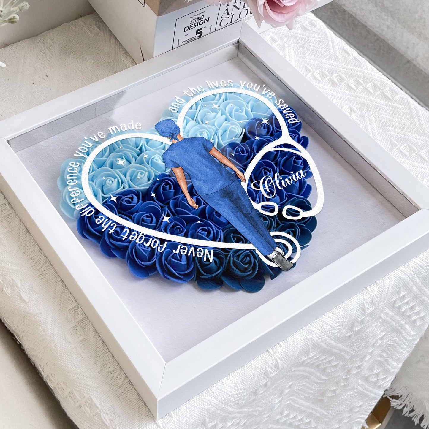 Heart-shaped flower shadow box for nurses and doctors, blue and white PE foam flowers, with stethoscope design.
